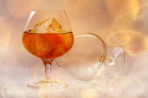 Glass of brandy with ice and smoke